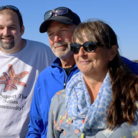 Parents with autistic son watching something in the distance